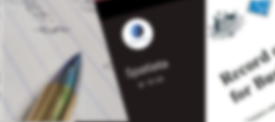 A blurred image of a pen, mobile phone and document